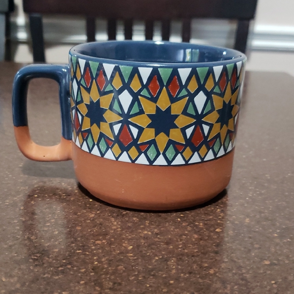 Kaleidoscope pattern. Terracotta. Capacity 14 ounces. 3.25L x 5W x 3H inches.